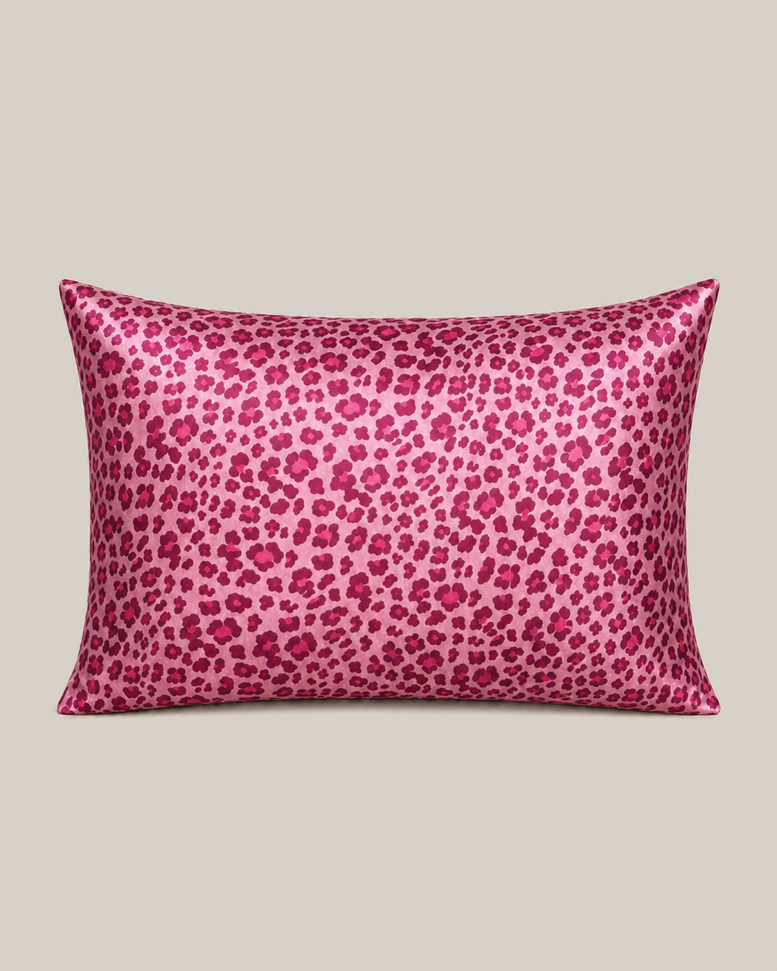 Barbie Pink Leopard 22 momme silk front pillowcase on a warm beige studio background.