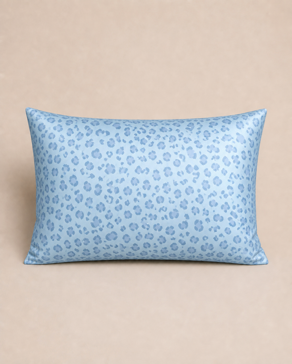 Blue Leopard 22 momme silk front pillowcase on a warm beige studio background.