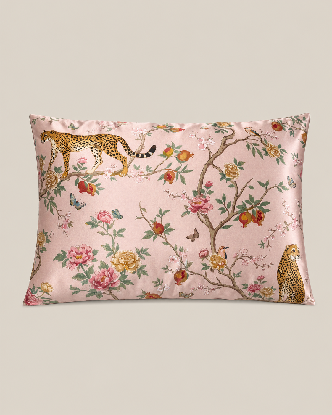 Blush Botanical Leopard 22 momme silk front pillowcase on a warm beige studio background.