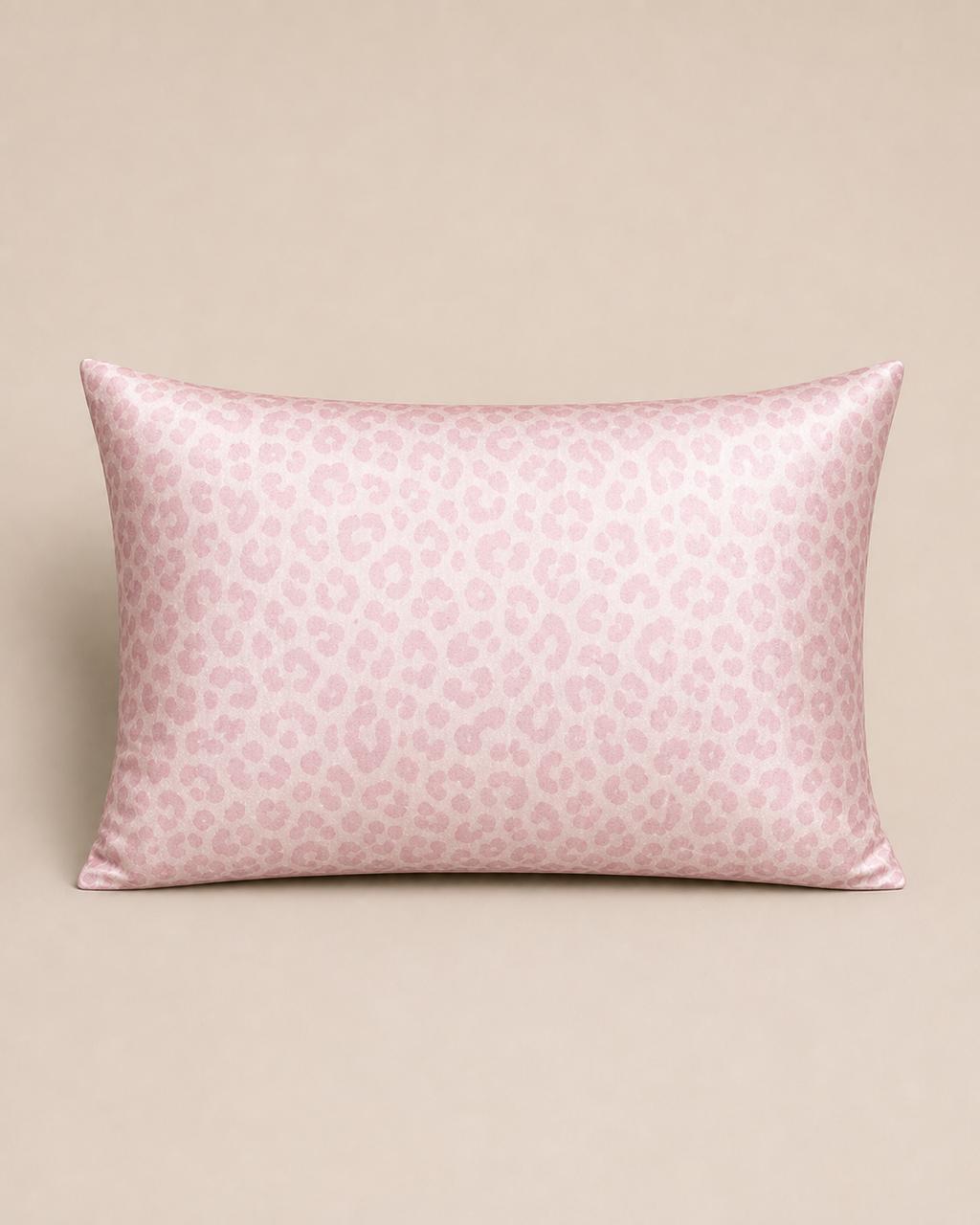 Pale Pink Leopard 22 momme silk front pillowcase on a warm beige studio background.