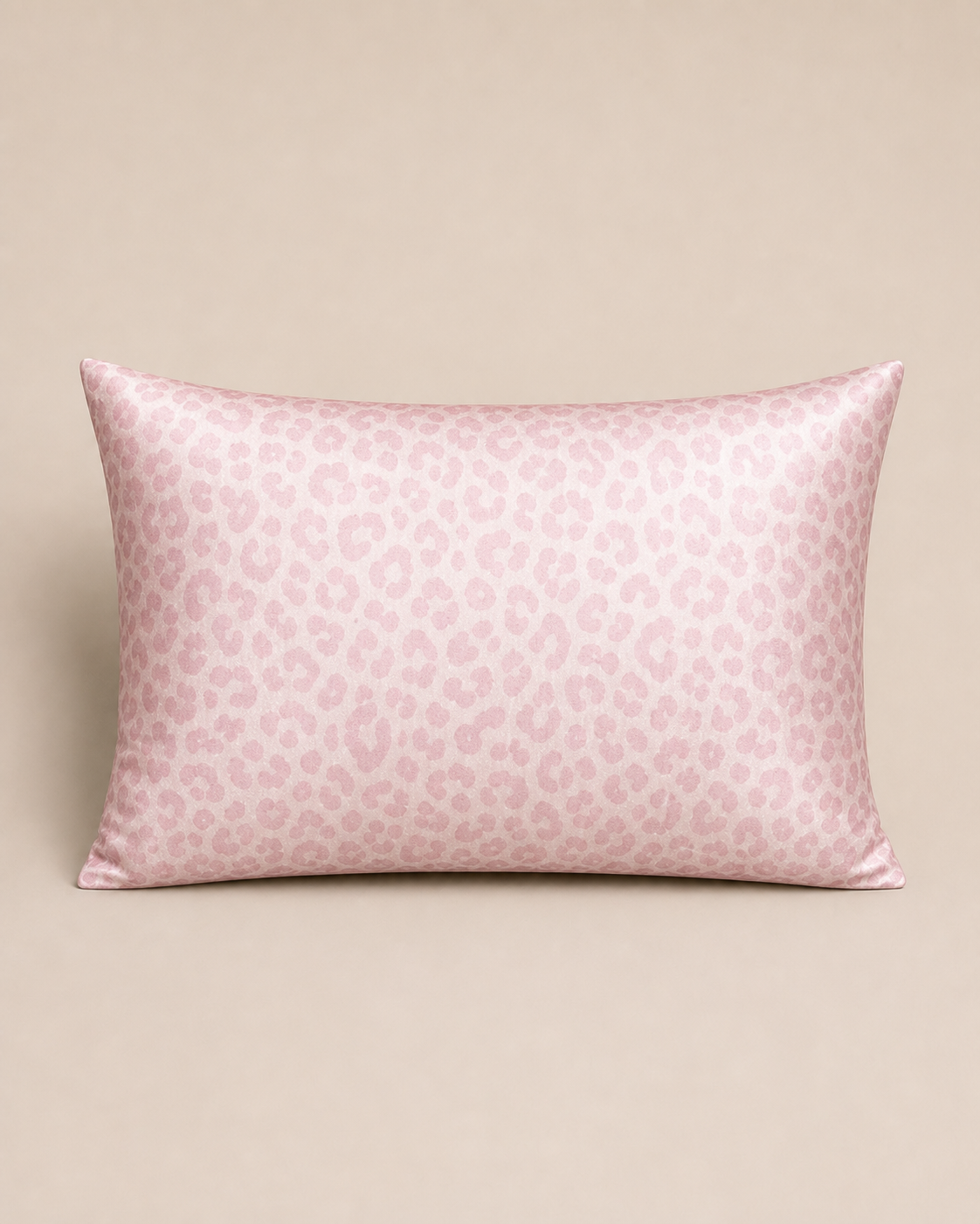 Pale Pink Leopard 22 momme silk front pillowcase on a warm beige studio background.