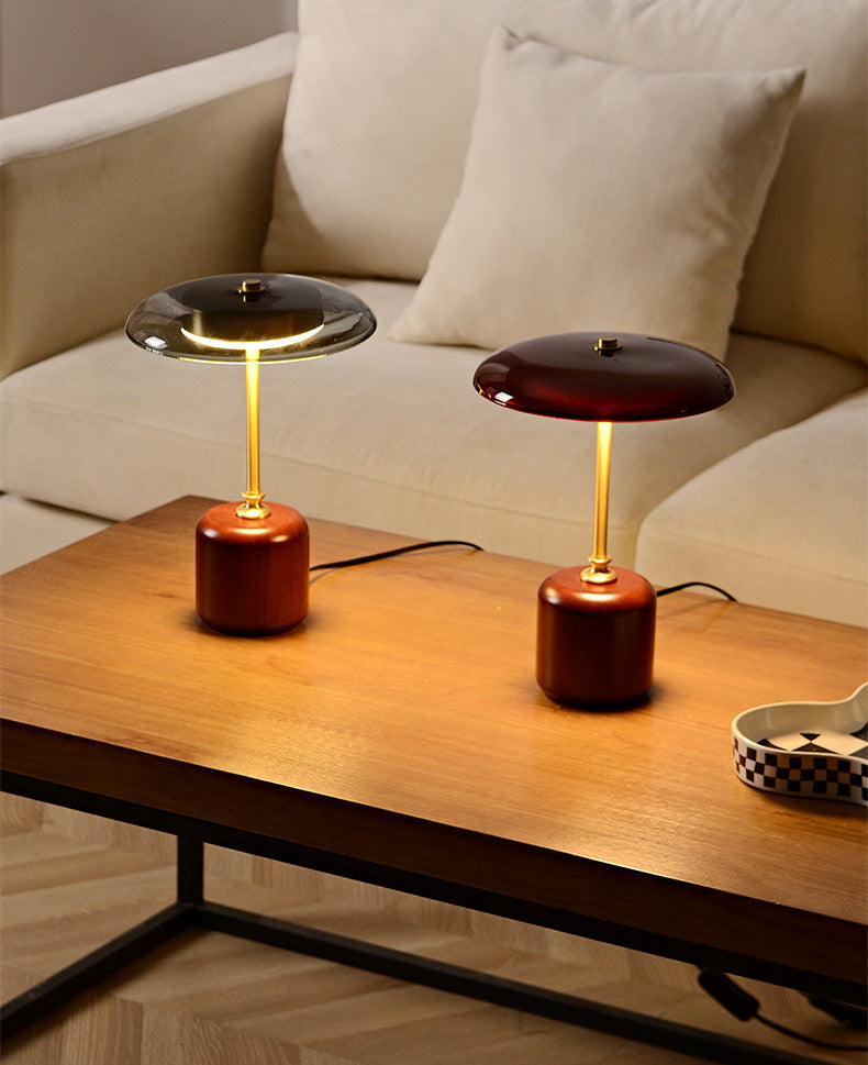 Two vintage-style American table lamps on a wooden surface with a neutral background