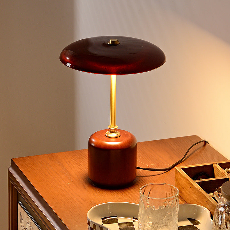 American MCM table lamp with a wooden base and dark brown shade on a wooden surface.