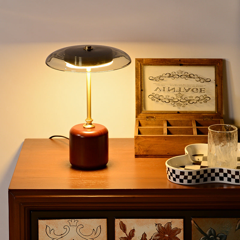 American MCM table lamp on a wooden surface with decorative items in the background