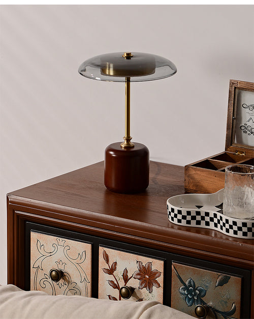 American MCM table lamp on a wooden sideboard with decorative elements