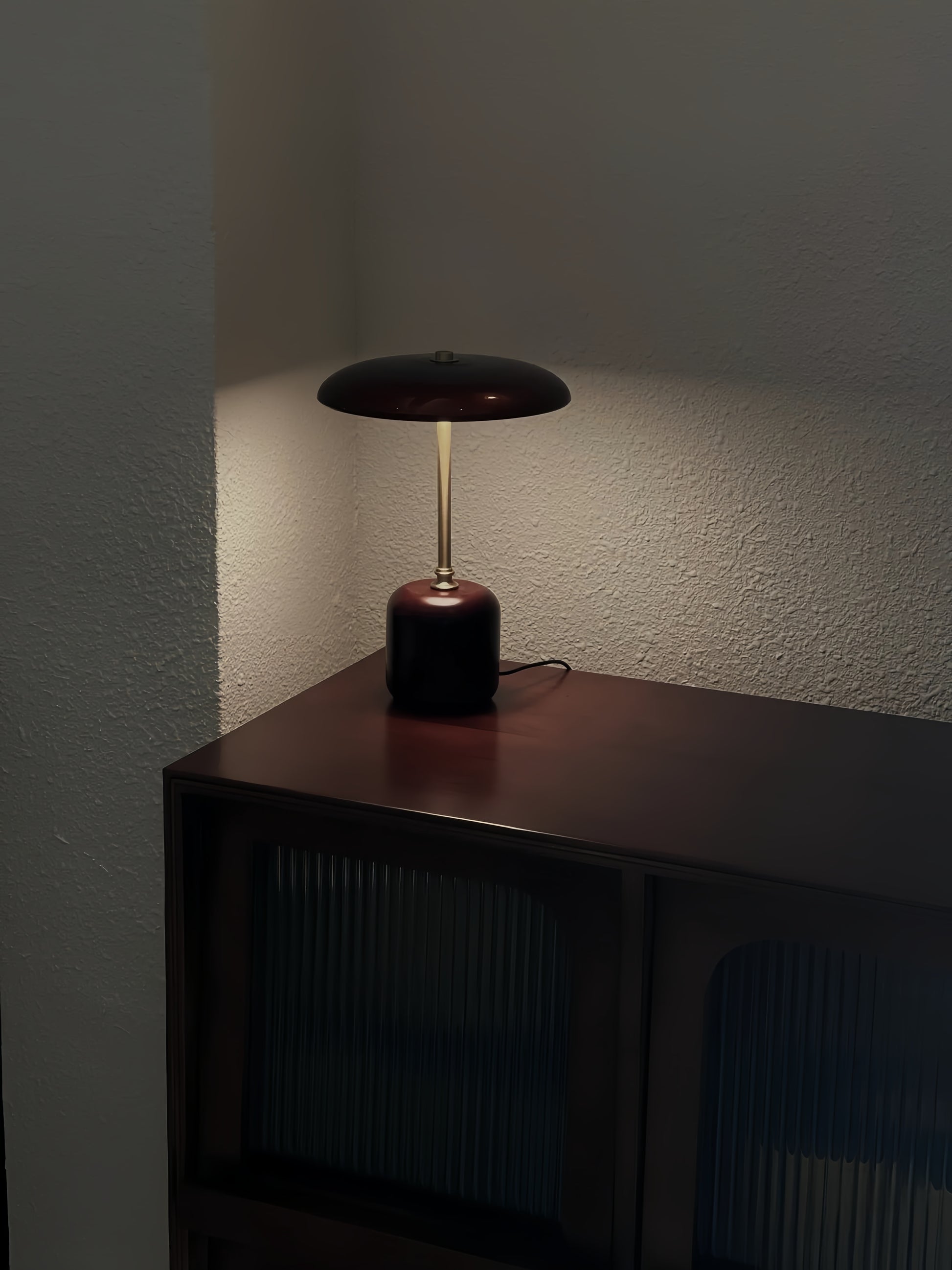 American MCM table lamp on a wooden surface against a plain wall