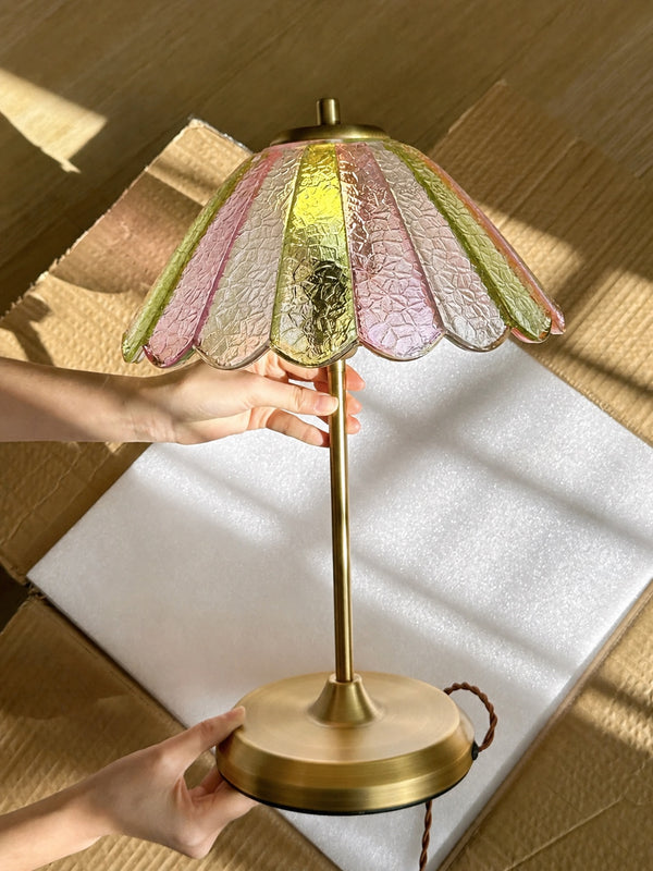 A customer unboxing offers a useful look at the scalloped glass edges, rippled surface, warm metallic finish, and real-life proportions. The broad circular base visually balances the delicate flower-like shade.