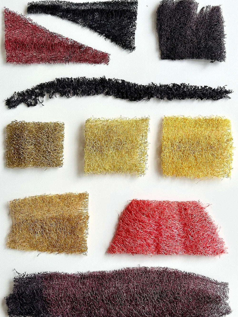 Flat lay of dyed loofah fiber panels in multiple colors for handmade natural lamp shades