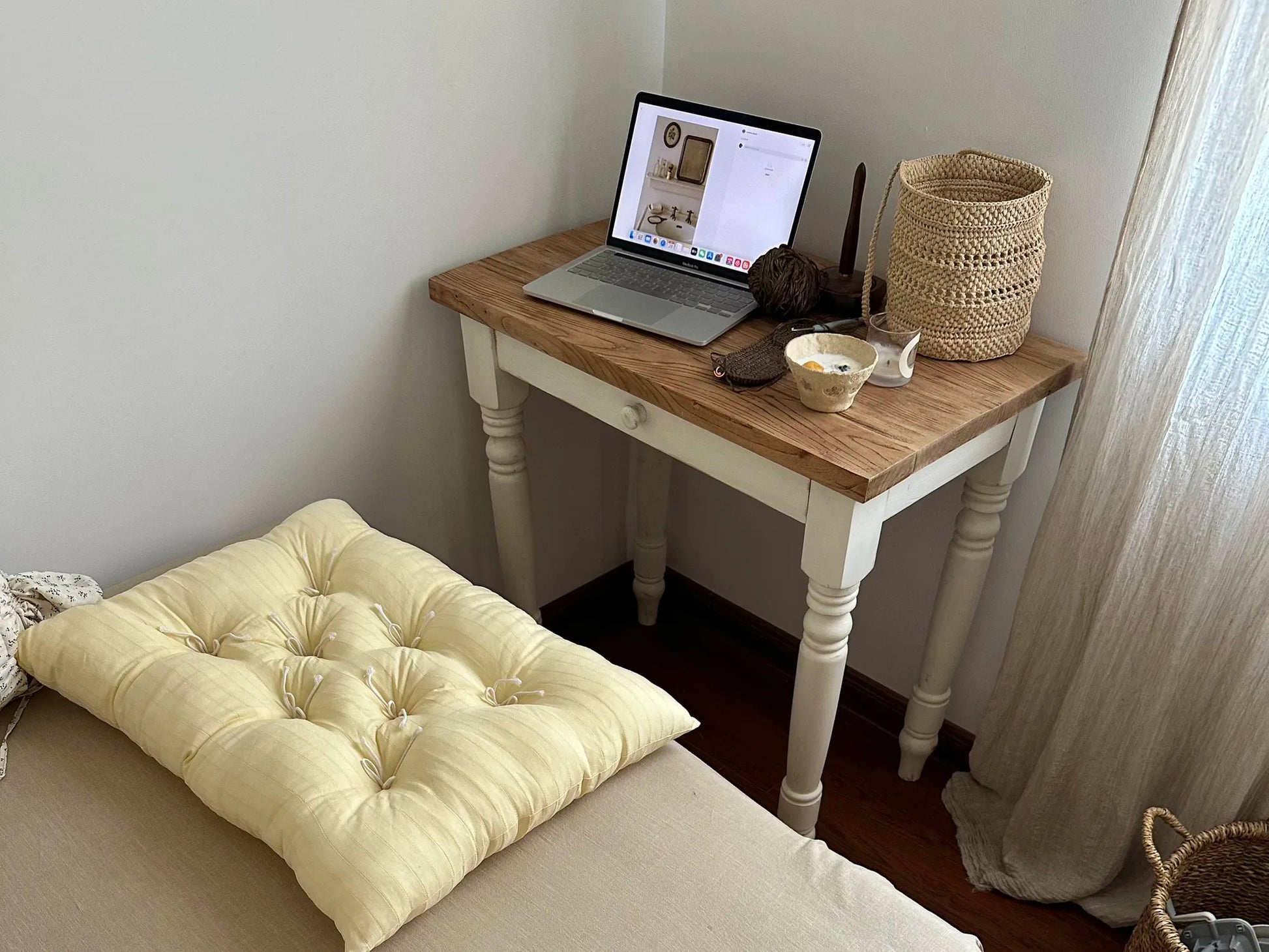 Cream Vertical Stripe French vintage patterned pillow cushion styled on a bed beside a small desk.