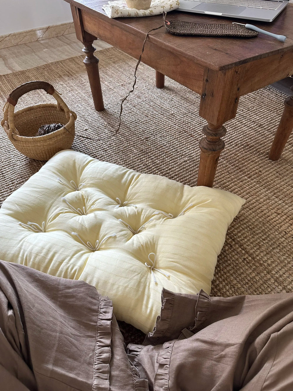 Cream Vertical Stripe French vintage patterned pillow cushion styled on the floor near a rustic coffee table.