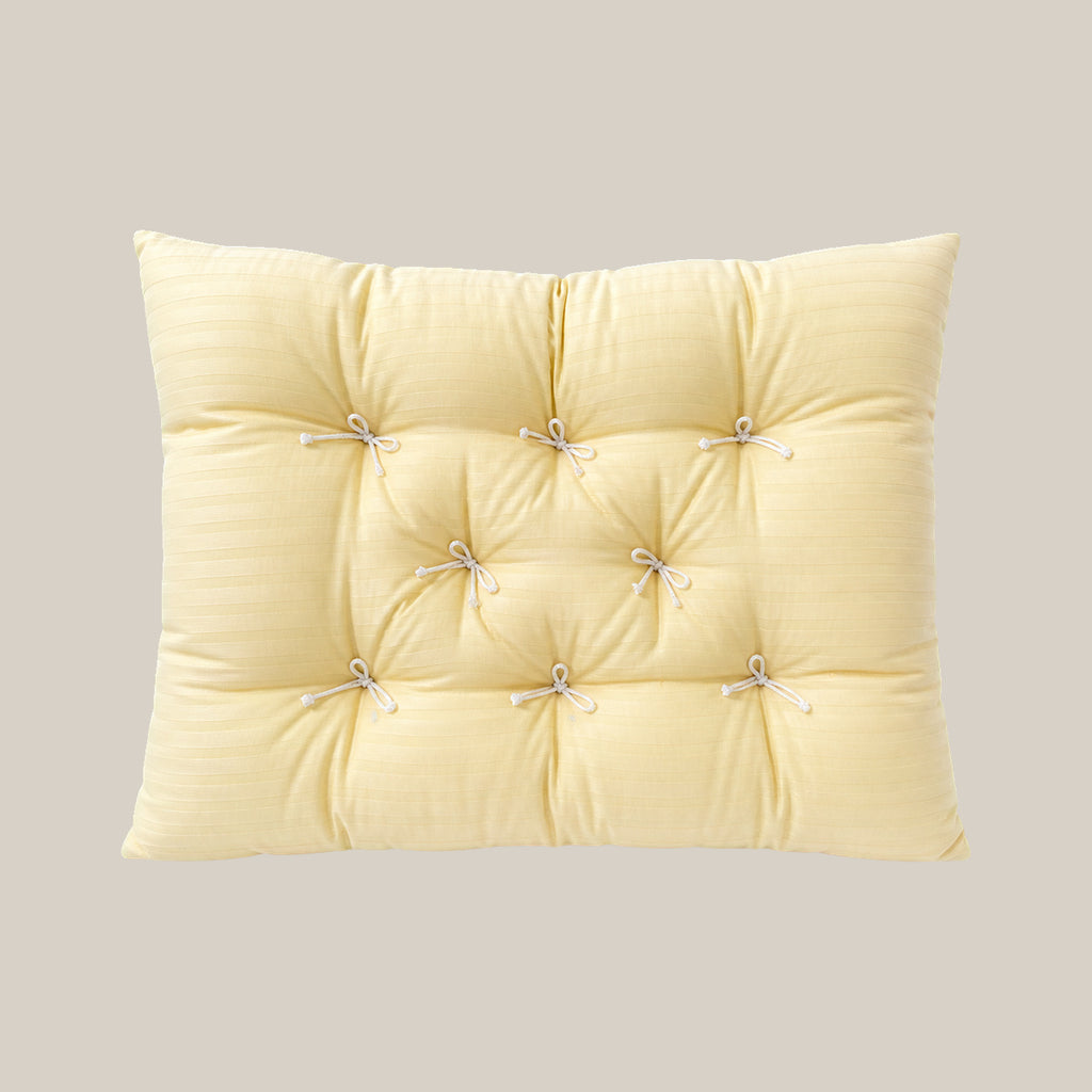 French vintage patterned pillow cushion in Cream Vertical Stripe style on a warm beige studio background.