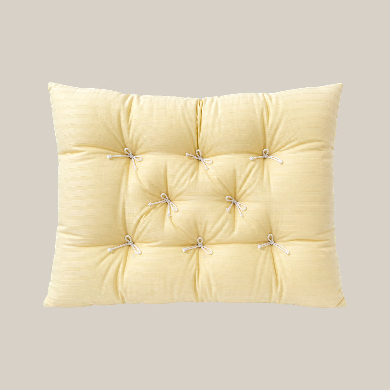 French vintage patterned pillow cushion in Cream Vertical Stripe style on a warm beige studio background.