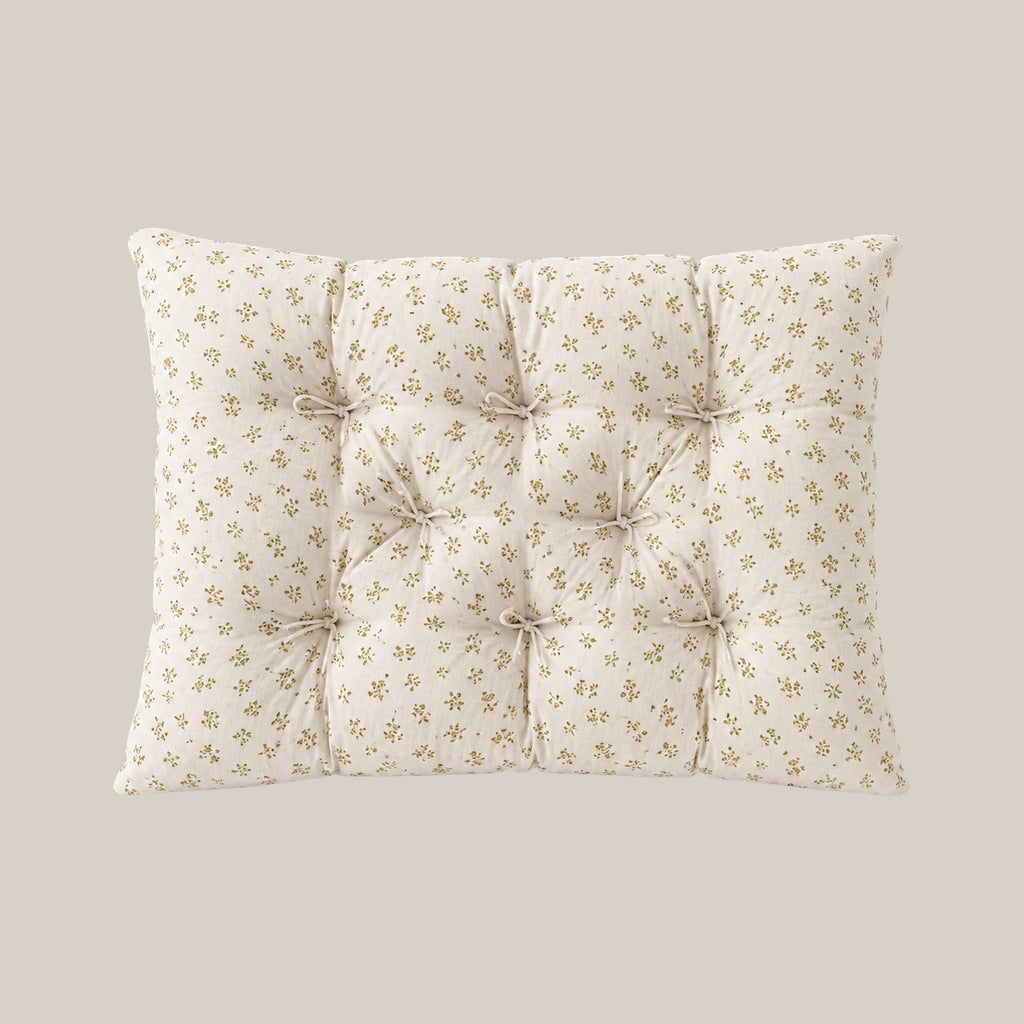 French vintage patterned pillow cushion in Mustard Floral style on a warm beige studio background.
