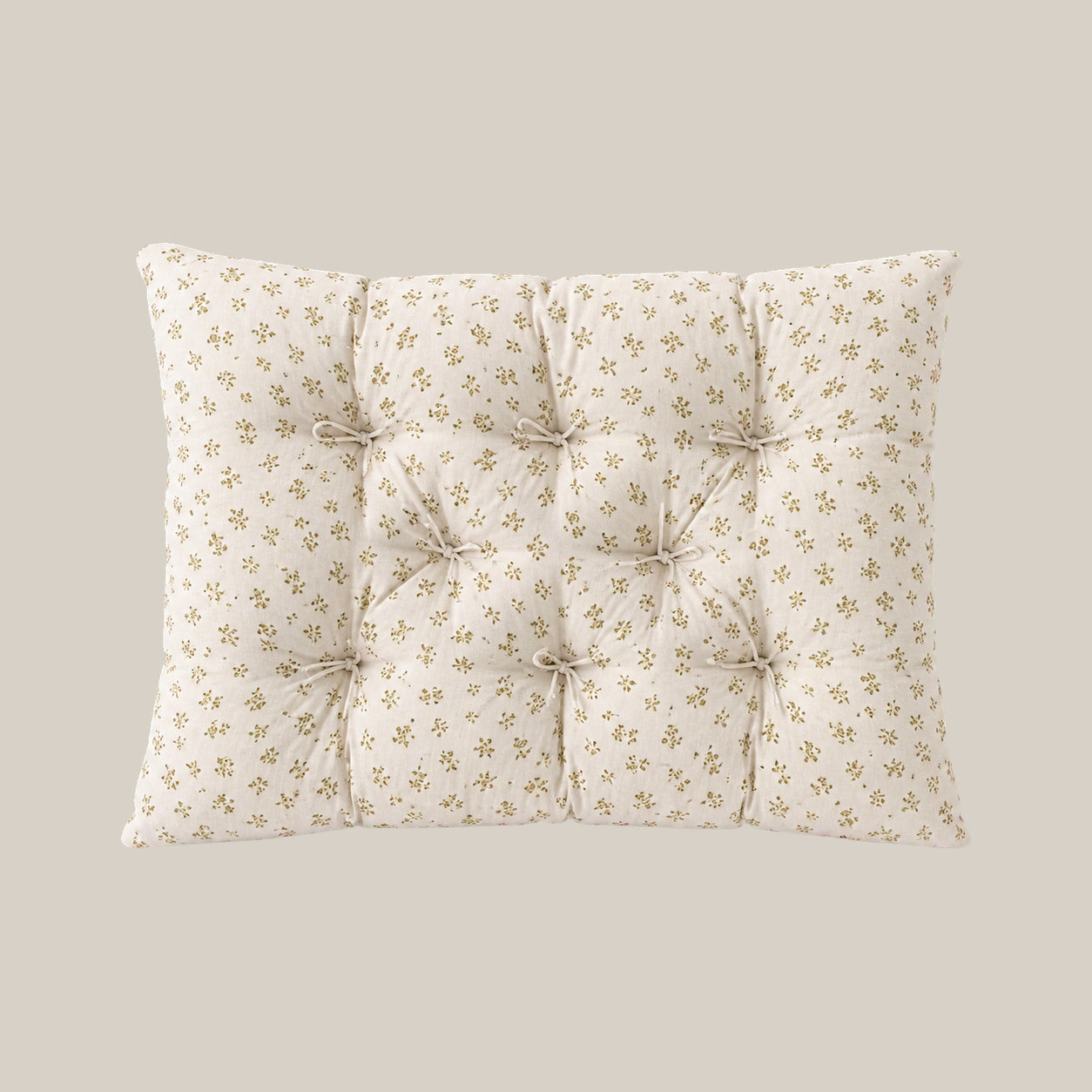 French vintage patterned pillow cushion in Mustard Floral style on a warm beige studio background.