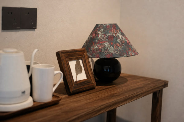 Even when unlit, the botanical shade and glossy green base create a distinctive decorative focal point.