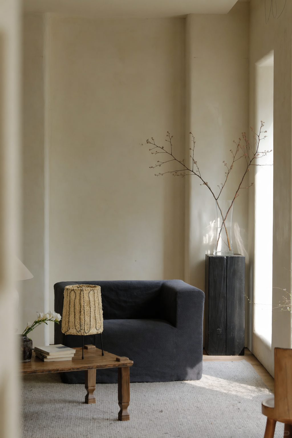 Loop loofah table lamp styled on a wooden coffee table in a calm wabi-sabi living room with natural light.