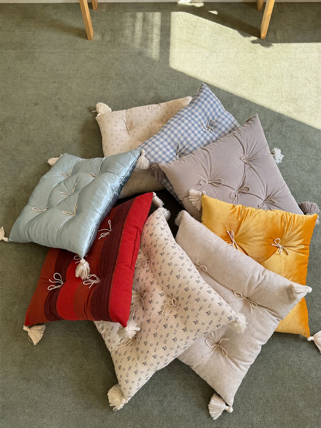 Mixed Mariette tufted tassel throw pillows arranged as a floor collection.