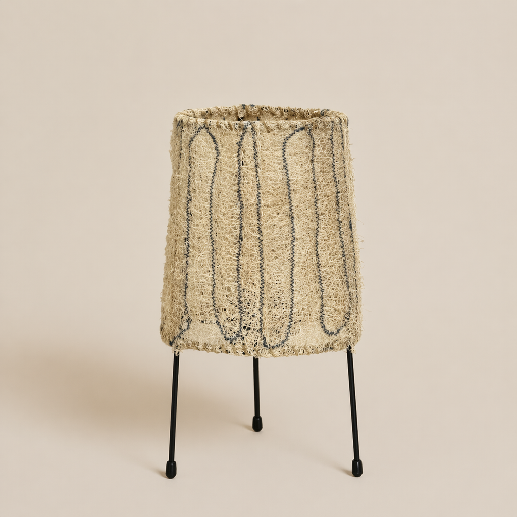 Textured lampshade on a stand against a beige background