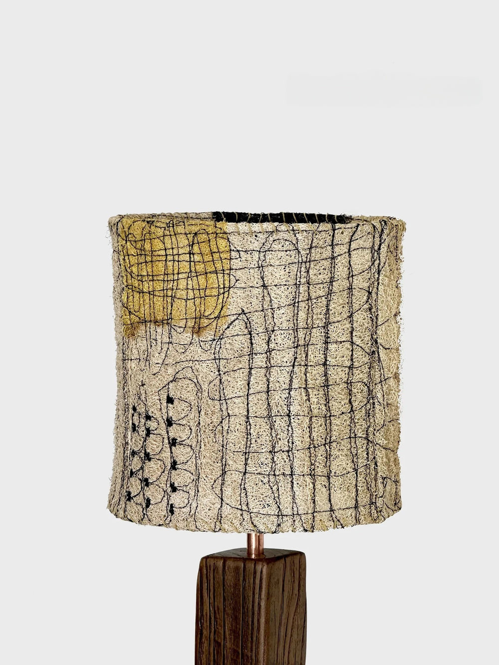 Lamp with a textured lampshade on a white background