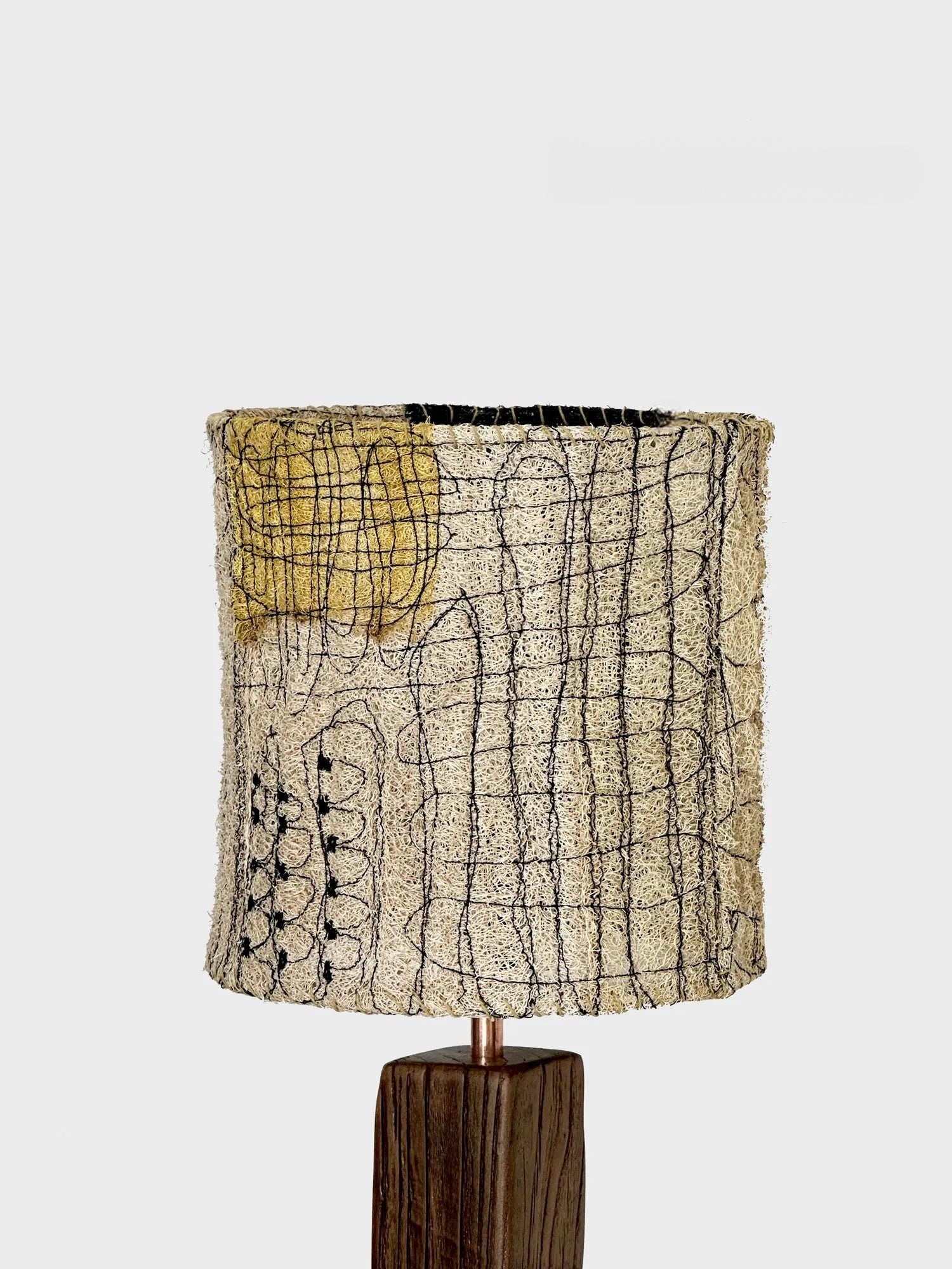 Lamp with a textured lampshade on a white background