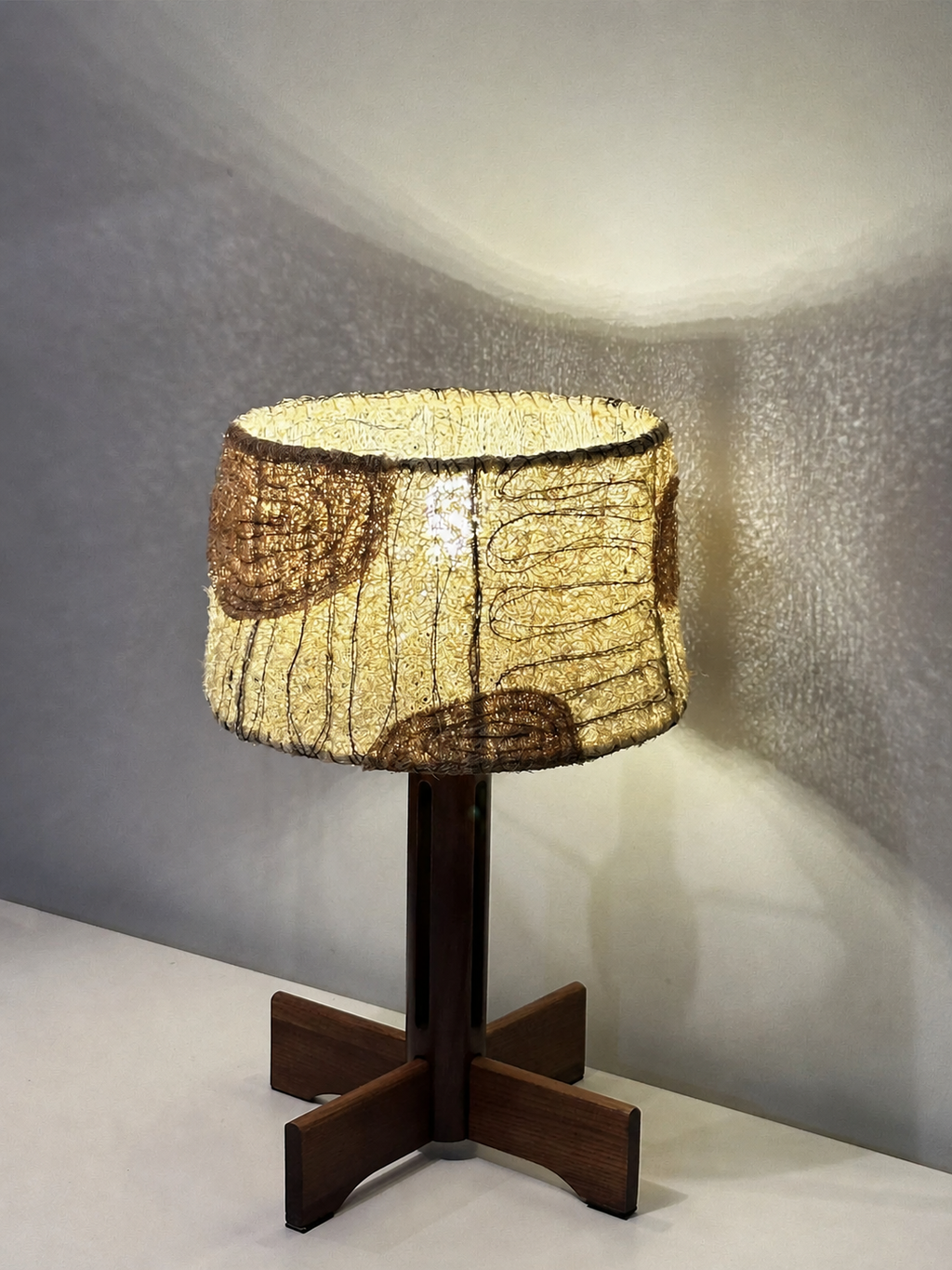 Petal blush loofah and solid wood table lamp illuminated with a warm textured glow