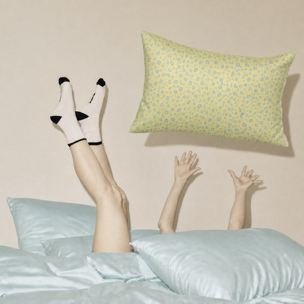 Yellow Leopard and Tiffany Blue 22 momme silk front pillowcases in a playful bedroom lifestyle scene.
