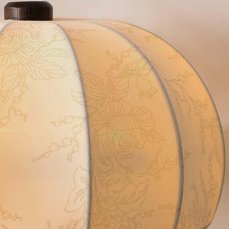 close-up highlighting the pleated floral embroidery on the cream fabric shade