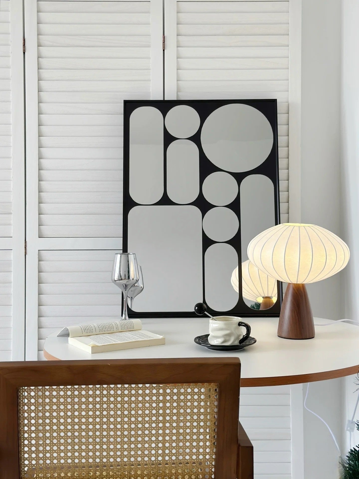 Modern interior with a table, chair, and decorative elements.