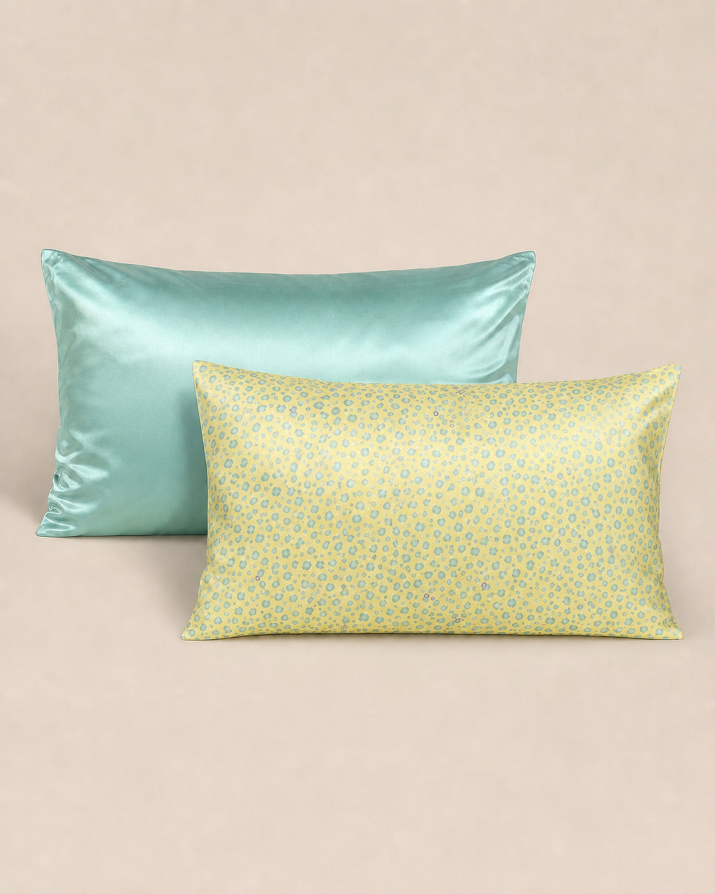 Tiffany Blue and Yellow Leopard 22 momme silk front pillowcases on a warm beige studio background.