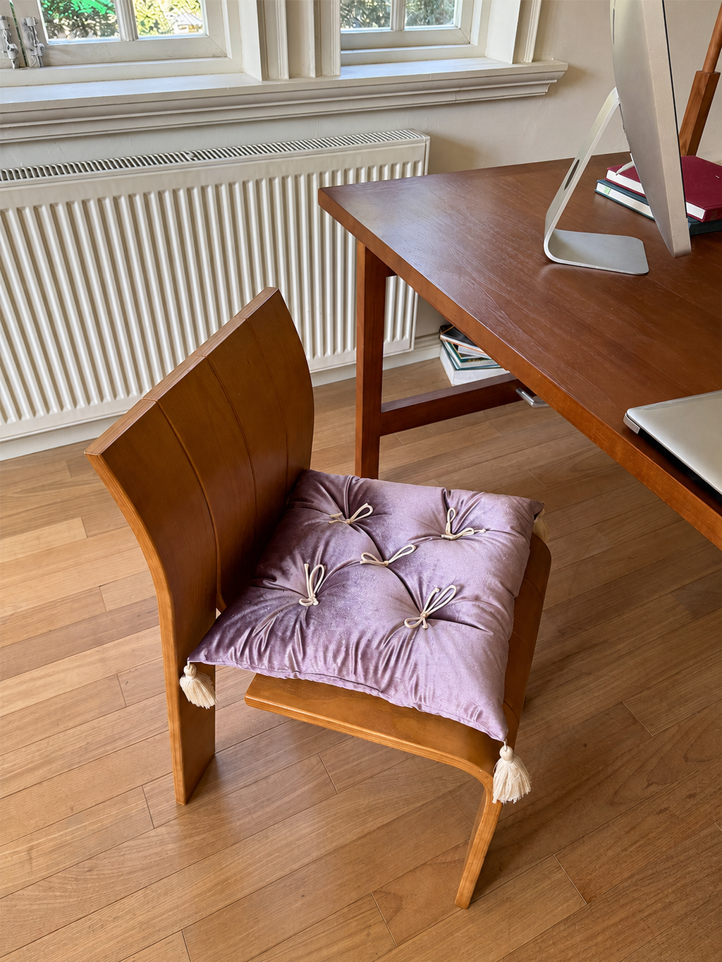 Purple Velvet Léonie tufted tassel throw pillow used as a desk chair cushion.